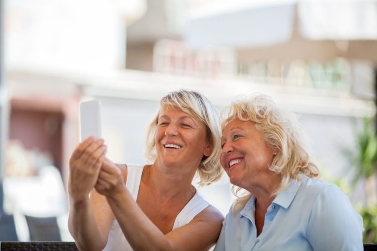 Happy senior women making mobile selfie